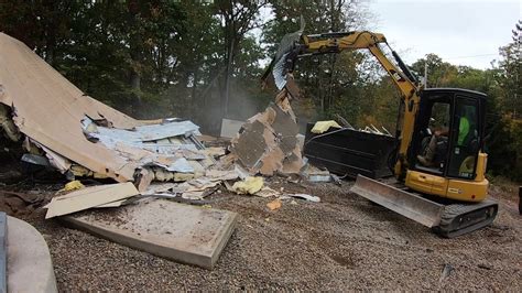 mini excavator knocking down a garage|mini excavator demolition.